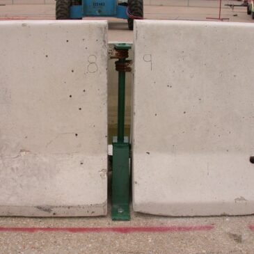 Tie-Down Strap System for F-Shape Concrete Barrier