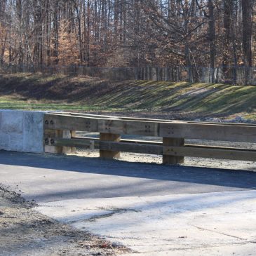 Median Steel-Backed Timber Guardrail to Stone-Faced Median Barrier Transition